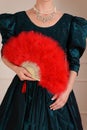 Closeup victorian woman holding feather fan