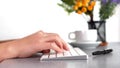 Closeup video of female hands, typing on the PS keyboard, at the table in the office.