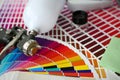 Closeup view of airbrush gun lying at colour check