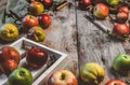 closeup view of apples, pears, wooden box, knife, scissors, hand scales and kitchen towel