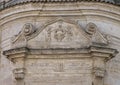 Closeup view of the architrave above the front door of the Church of Purgatory, Matera