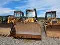 Closeup view of backhoe loaders on a gravel road