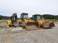 Closeup view of backhoe loaders on a gravel road