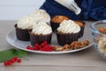 Closeup view of baker decorating tasty cupcake with creamy Royalty Free Stock Photo