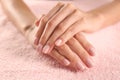 View of beautiful female hands on roze towel. Spa treatment. Royalty Free Stock Photo