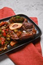 Closeup view of beef ossobuco and chopped vegetables in plate Royalty Free Stock Photo
