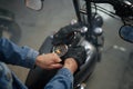Closeup view on biker hand wearing leather gloves over motorcycle gas tank Royalty Free Stock Photo