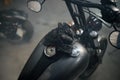 Closeup view on biker leather gloves on motorcycle gas tank Royalty Free Stock Photo