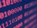 Closeup view of binary computer code with pink 1s and 0s displayed on a blue screen with focus blur effect Royalty Free Stock Photo