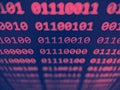 Closeup view of binary computer code with 1s and 0s displayed on a screen with focus blur effect in pink and blue