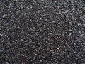 Black colored volcanic pebble stones with ground round shape at the famous beach Reynisfjara on the southern coast of Iceland. Royalty Free Stock Photo