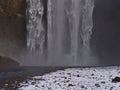 Closeup view of the bottom of famous waterfall SkÃÂ³gafoss with spray in winter with snow in the south of Iceland. Royalty Free Stock Photo