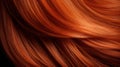 A closeup view of a bunch of shiny straight red hair in a wavy curved style.