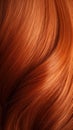 A closeup view of a bunch of shiny straight red hair in a wavy curved style.