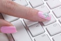 Closeup view of a business woman hand typing on wireless computer keyboard on office table. Soft lightning Royalty Free Stock Photo