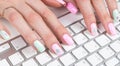 Closeup view of a business woman hands typing on wireless computer keyboard on office table Royalty Free Stock Photo