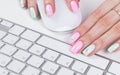 Closeup view of a business woman hands using and typing onwireless computer keyboard and mouse Royalty Free Stock Photo