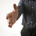 Closeup view of a businessman offering his hand in a handshake Royalty Free Stock Photo