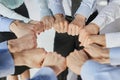 Hands, teamwork and motivation with a team of business people joining their fists in a huddle or circle. Royalty Free Stock Photo