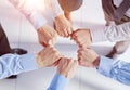 Closeup view businesspeople standing in circle fists bumping showing unity Royalty Free Stock Photo