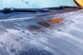 Closeup view of car parked at outdoor car parking lot that windshield and bonnet covered by freezing rain and small ice Royalty Free Stock Photo