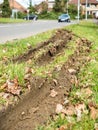 Closeup view of car wheel tracks traces in mud next to British road Royalty Free Stock Photo