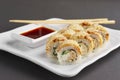 Chicken teriyaki roll with chopsticks and soy sauce