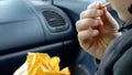 Closeup view child boy hand holding and eating biscuits while traveling in car Royalty Free Stock Photo