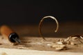 closeup view of chisel and wooden scobs on blurred black background