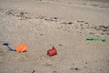 Closeup view of colorful children plastic toys left or forgotten at Sandymount Beach after messy sea activities during lowest tide Royalty Free Stock Photo