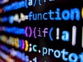 Closeup view of computer code displayed on pixelated screen with bright colorful words on dark background