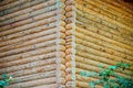 Closeup view of corner of wooden house made of natural logs - wooden construction background Royalty Free Stock Photo