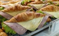Closeup view. Croissant with ham and cheese on tray