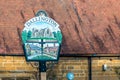 Closeup view of Dallington Village Sign Post Northampton UK