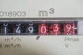 A closeup view of the dial or face of a metric gas meter in home