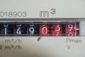 A closeup view of the dial or face of a metric gas meter in home