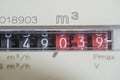 A closeup view of the dial or face of a metric gas meter in home