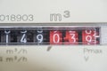 A closeup view of the dial or face of a metric gas meter in home