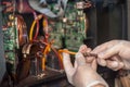 Closeup view of electrical engineer operator repairs industrial printer plotter