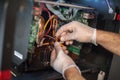 Closeup view of electrical engineer operator repairs industrial printer plotter