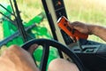 closeup view of farmer& x27;s hands driving combine harvester, tractor operating controlling machinery