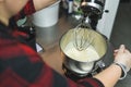 closeup view of a female baker mixing products in the modern kitchen stand mixer