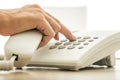 Closeup view of female secretary dialing a telephone number on w Royalty Free Stock Photo