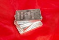 Closeup view of Fine Silver Bars on red background Royalty Free Stock Photo