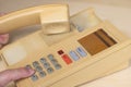 Closeup view of finger dialing telephone number on old style wired desktop telephone - studio shot Royalty Free Stock Photo