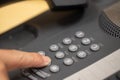 Closeup view of finger dialing telephone number on old style wired desktop telephone - studio shot Royalty Free Stock Photo