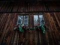 Closeup view of flowers on wooden window sill boat house of Lago di Braies Pragser Wildsee Dolomites South Tyrol Italy Royalty Free Stock Photo