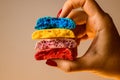 Closeup view of four sweet multicolored blanks of macaron broken in half in female hands