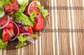 Closeup view on a fragment of a plate with fresh salad of raw to Royalty Free Stock Photo