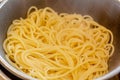 Closeup view of fresh boiled spaghetti pasta inside colander. Shallow depth of field Royalty Free Stock Photo